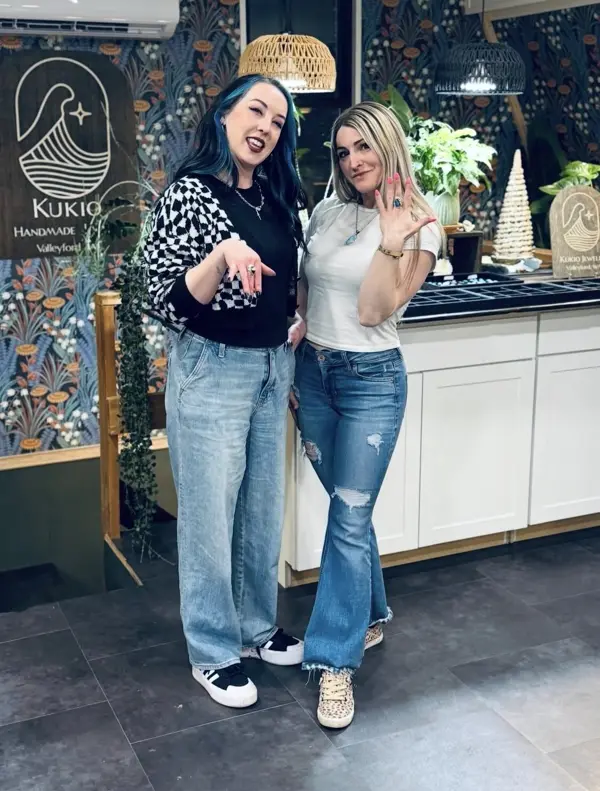 Two friends in the studio after class, showing their new rings