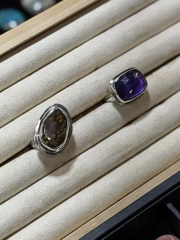 Two finished sterling rings, one amber and one amethyst
