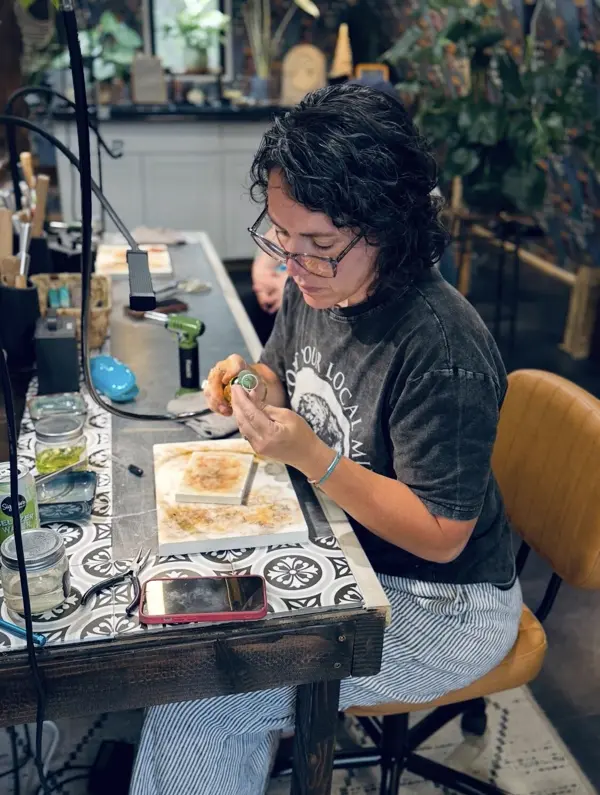 A student working on her ring at the bench